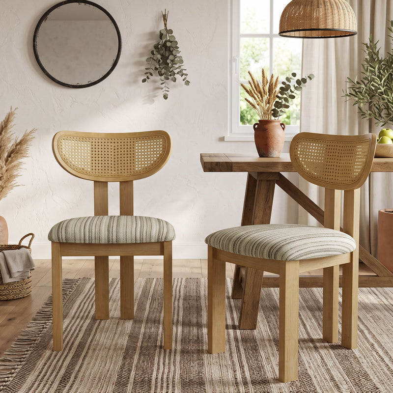 Dining chairs with curved rattan backs, striped fabric seats, and wooden legs