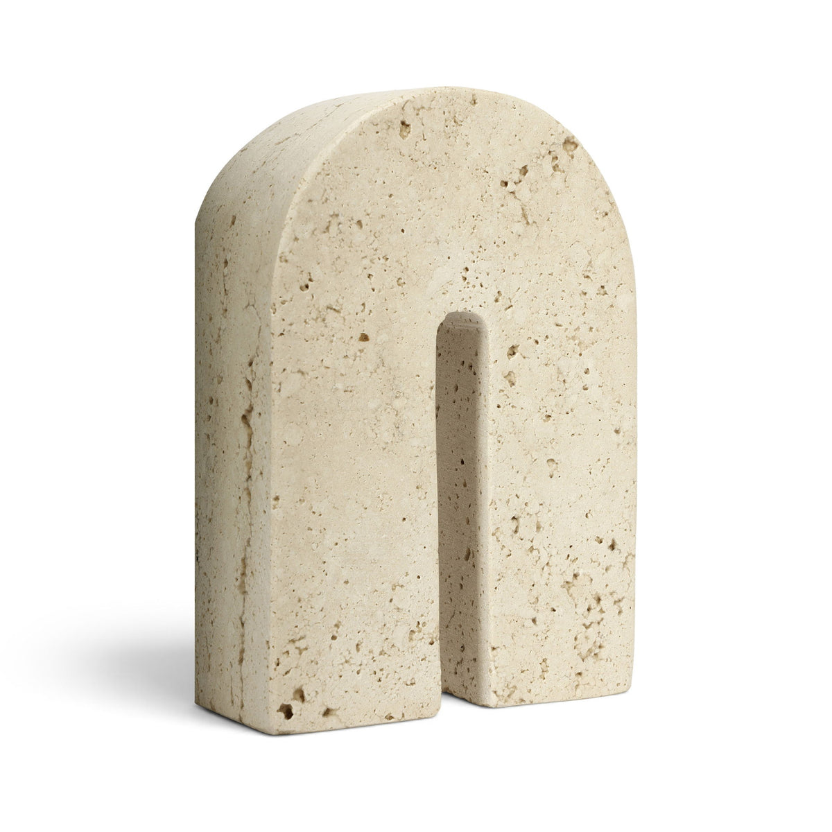 Beige travertine bookend with centered vertical slot, speckled stone finish