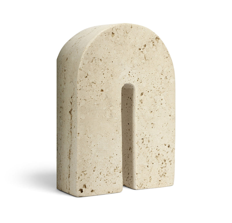Beige travertine bookend with centered vertical slot, speckled stone finish