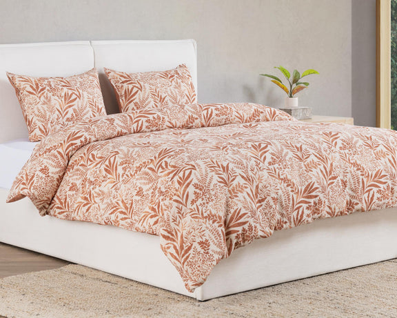 Chestnut orange leaf-pattern duvet with matching pillowcases on a bed