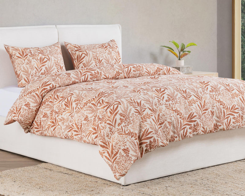 Chestnut orange leaf-pattern duvet with matching pillowcases on a bed