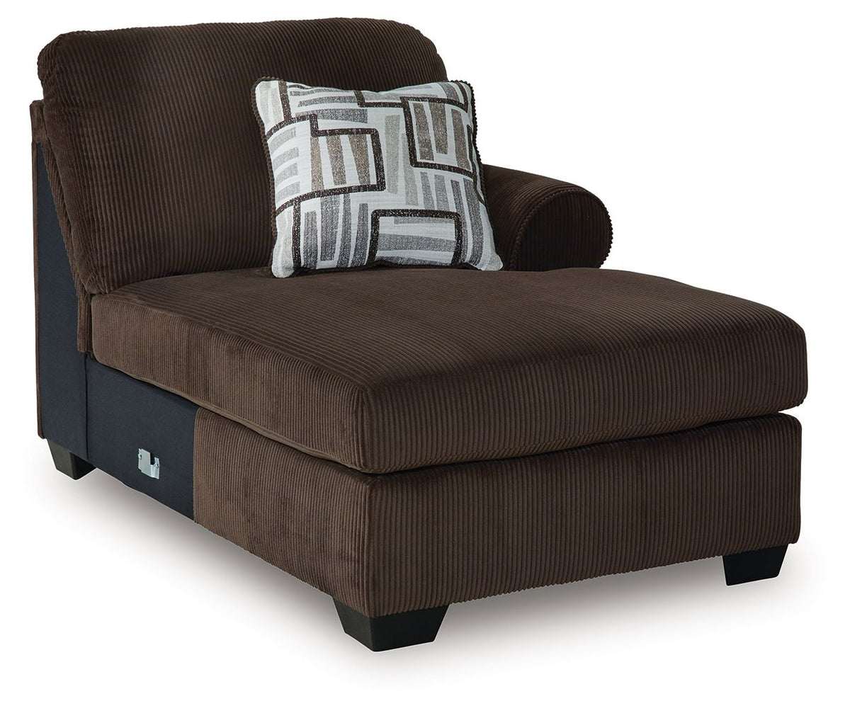 Dark brown chaise lounge with patterned throw pillow and textured striped upholstery