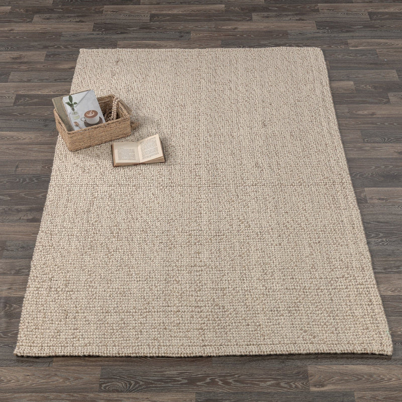 Natural woven area rug with small decor items placed on the surface