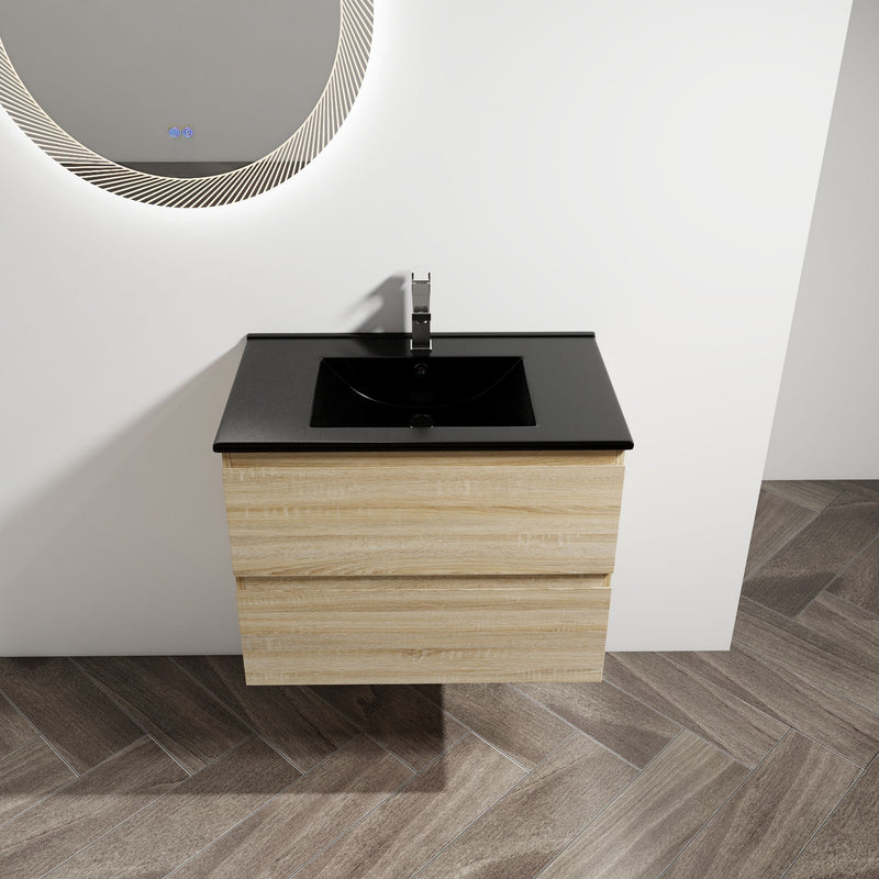 Wall-mounted bathroom vanity with black sink basin and light wood cabinet with drawer fronts