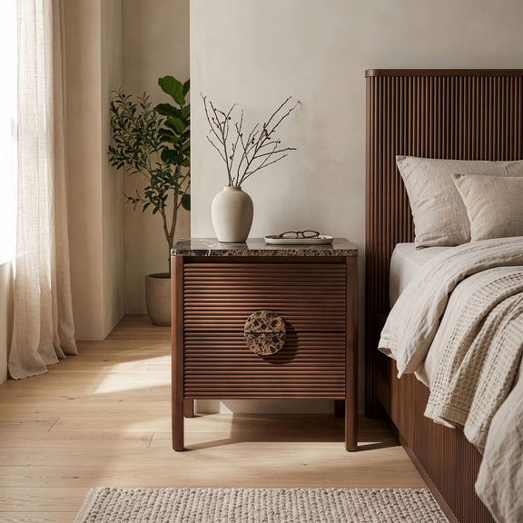 Dark brown acacia wood nightstand with speckled stone top and darker round drawer pull