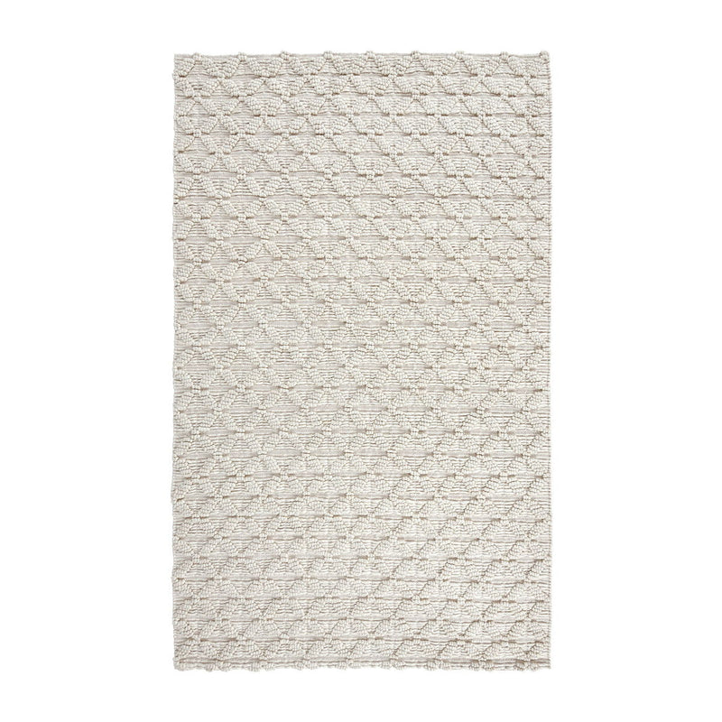 Ivory patterned area rug with textured grid design and short pile.