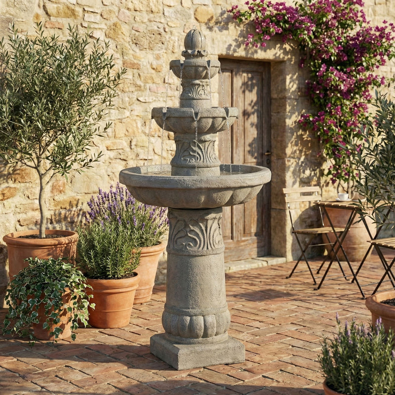 Gray 3-tier garden fountain with carved column and wide top basin in an outdoor patio