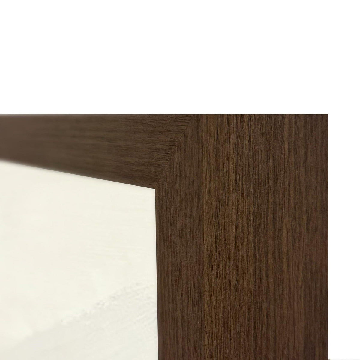 Dark brown picture frame edge with wood grain beside white canvas corner.