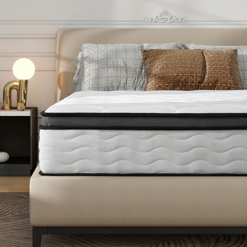 White hybrid mattress on a bed frame with black-trim edge and quilted surface