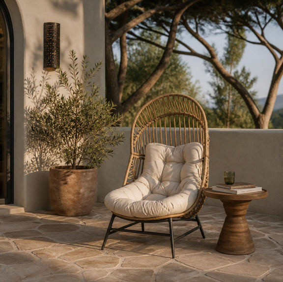 Light brown rattan lounge chair with beige cushion on outdoor patio
