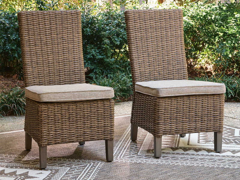 Pair of beige woven side chairs with light beige cushions on dark legs