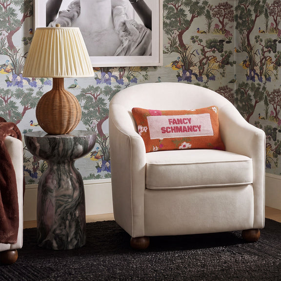 White performance velvet accent chair with upholstered armchair design and patterned text pillow