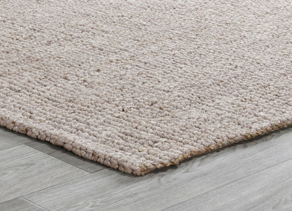 Beige chunky loop rug corner showing dense loop pile and low flat weave