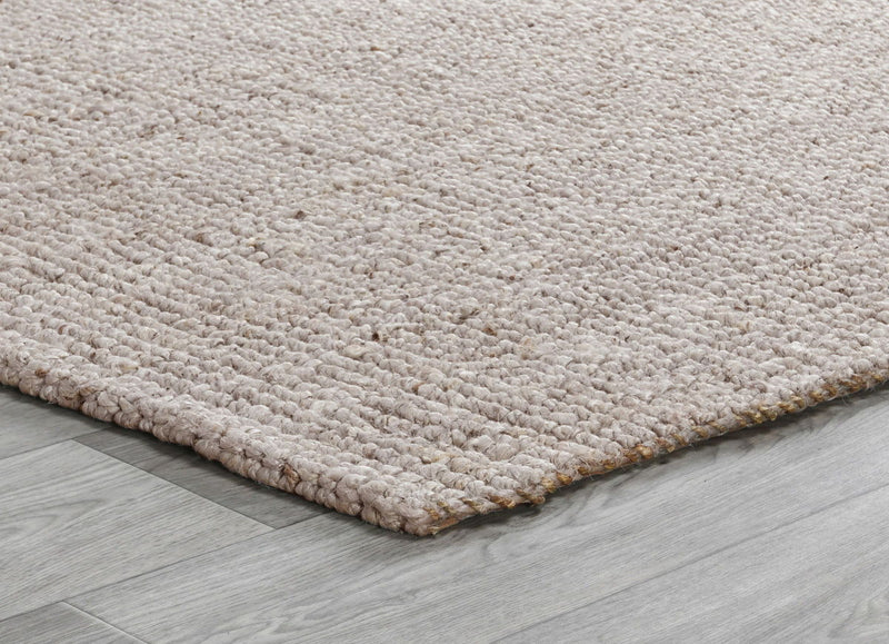 Beige chunky loop rug corner showing dense loop pile and low flat weave