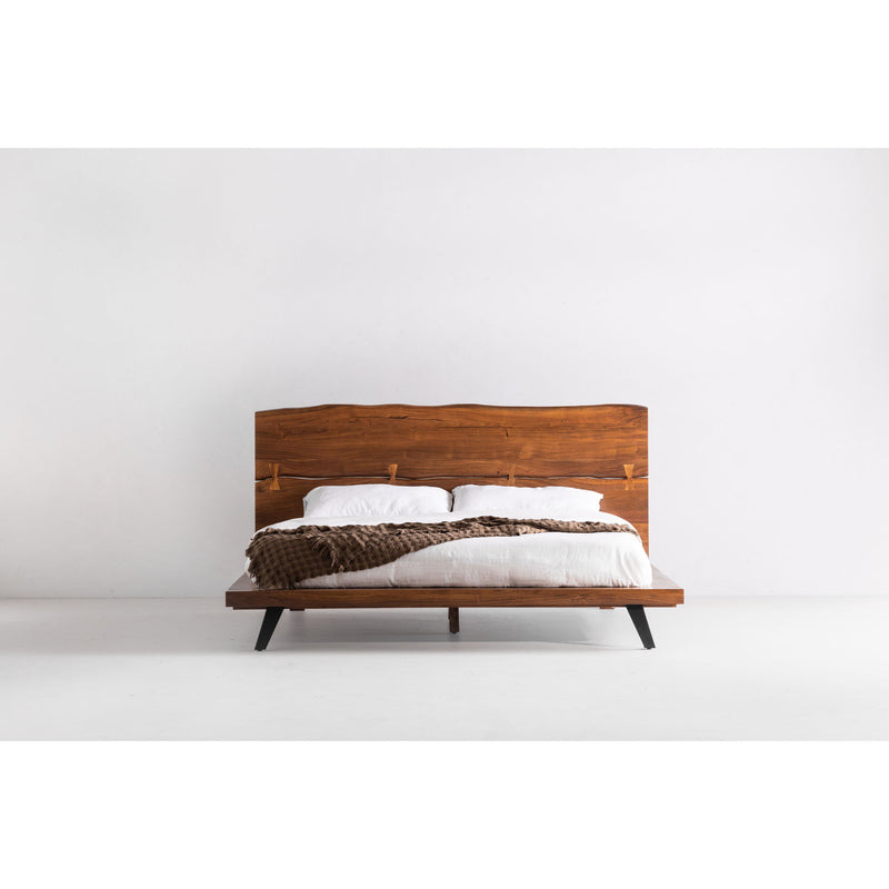 King platform bed with light brown wood headboard, white duvet, dark angled legs
