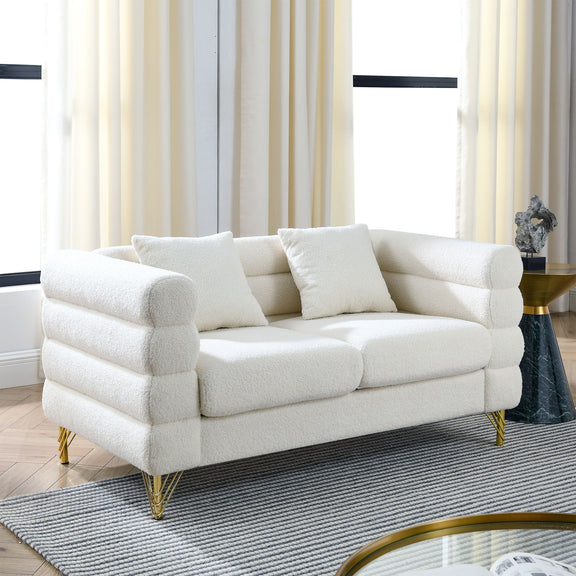 Beige sectional sofa with rounded arms, tufted cushions, and gold metal legs