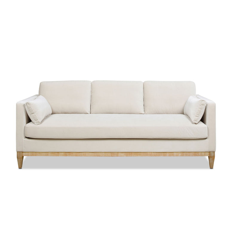 Modern farmhouse sofa in beige with three back cushions and light wood legs