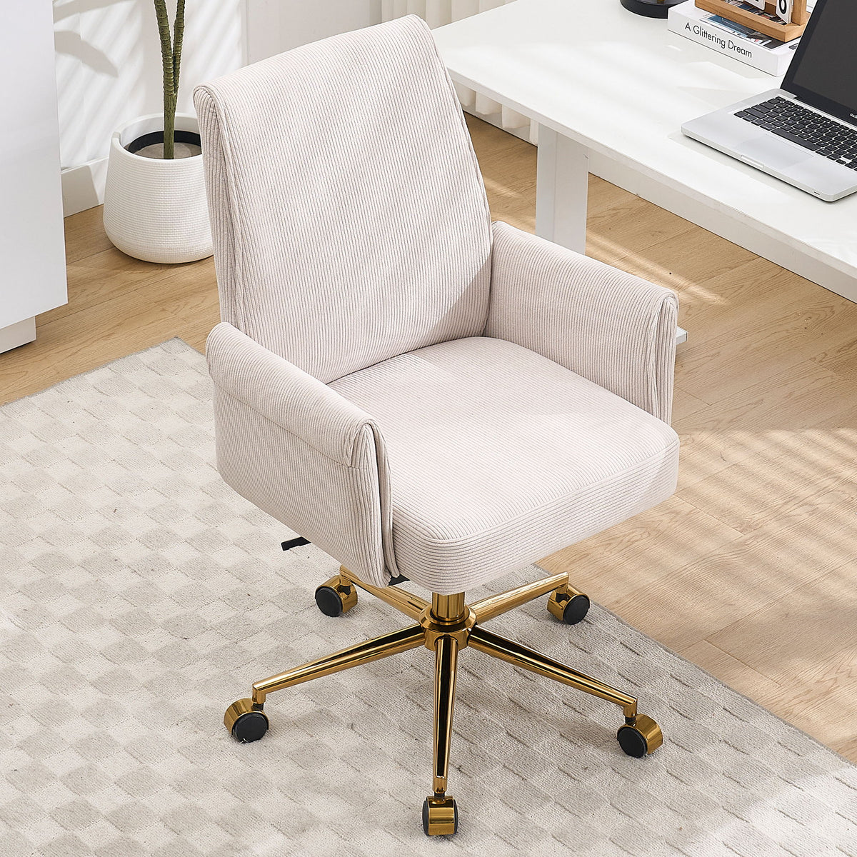 Light beige upholstered office chair with gold cross base, padded arms, and rolling casters