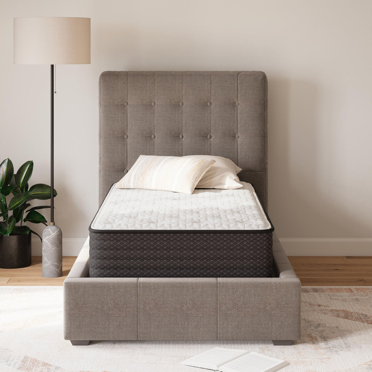 White plush mattress with quilted top and dark base, shown on bed