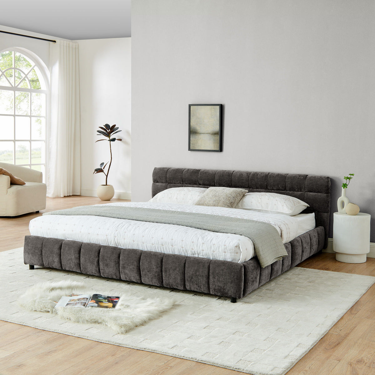 Upholstered platform bed frame with dark gray padded panels, channel headboard, platform base