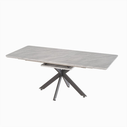 Light gray extendable dining table with lift-top center and crossed tripod legs