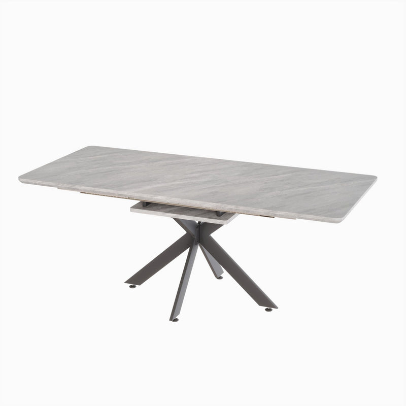 Light gray extendable dining table with lift-top center and crossed tripod legs