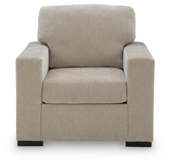 Light brown upholstered accent chair with tall back cushion, padded seat, and square armrests.