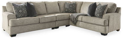 Beige sectional sofa with chaise and dark patterned throw pillows