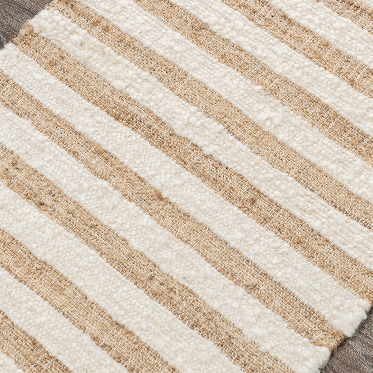 Natural striped area rug close-up showing cream and tan woven horizontal lines