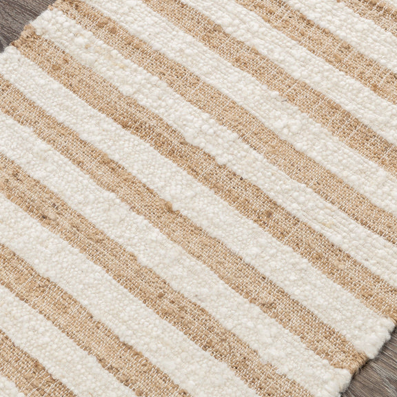 Natural striped area rug close-up showing cream and tan woven horizontal lines