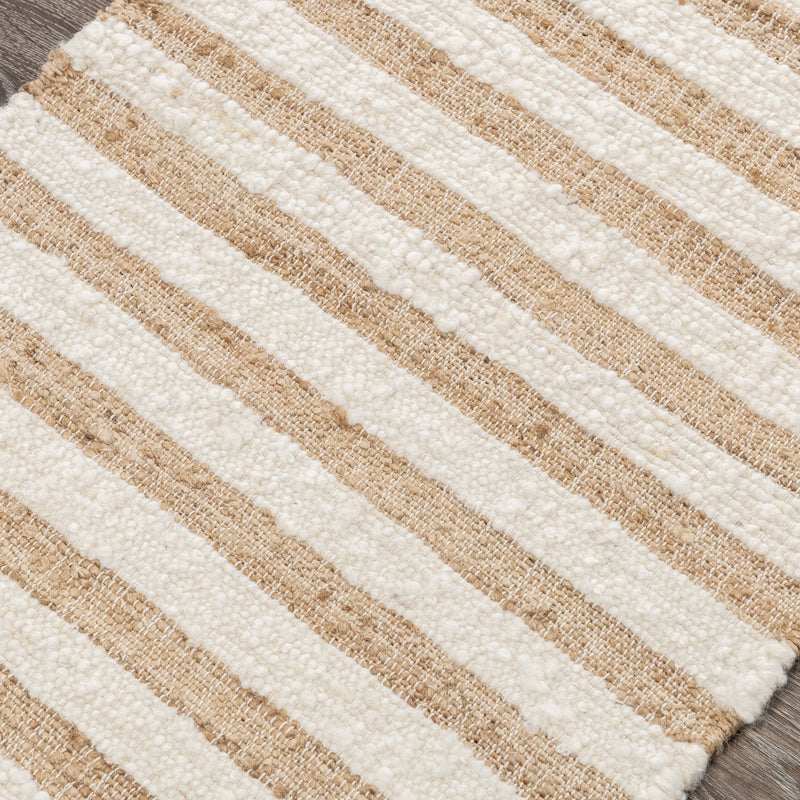 Natural striped area rug close-up showing cream and tan woven horizontal lines