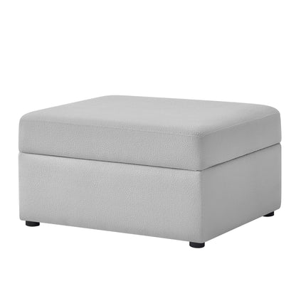 Gray upholstered storage ottoman with square padded top and tapered sides