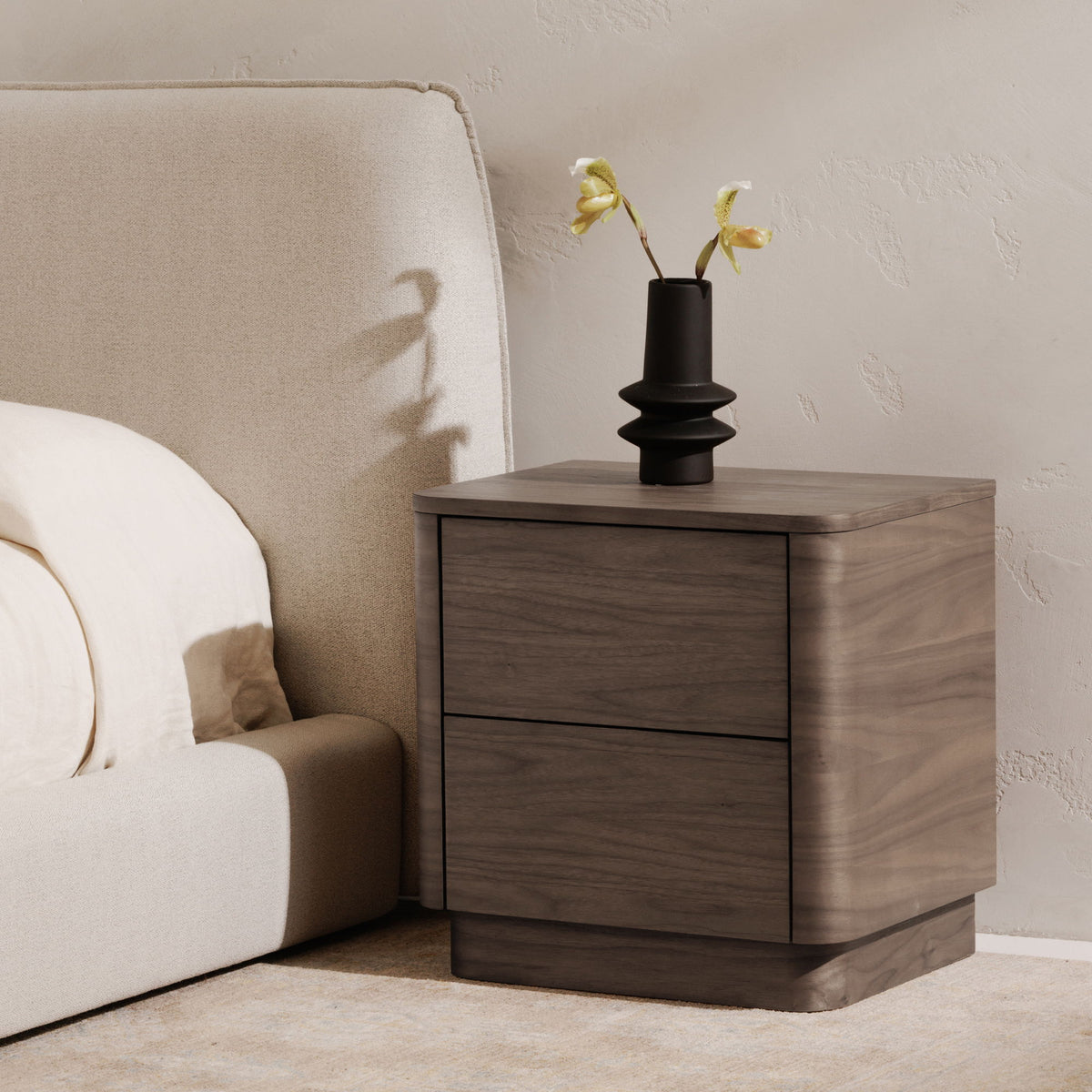Walnut two-drawer nightstand with smooth top and dark drawer trim line.